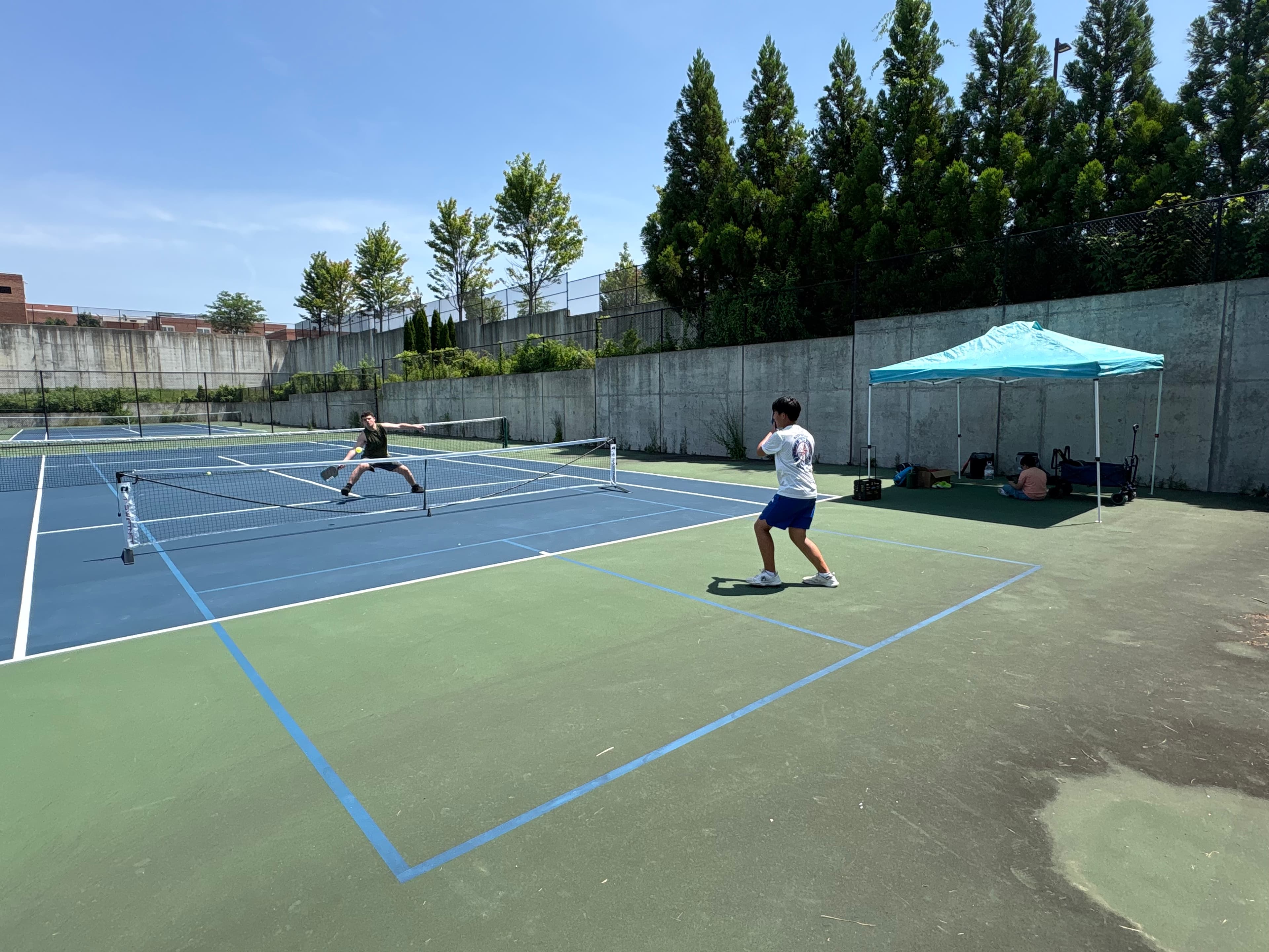 Players rallying on the courts at a Next Gen Pickleball Academy summer camp.